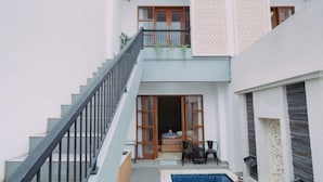 A two-story building with a staircase, a balcony, and a pool area. - The Lavana Nakula Villa Kuta Sunset (Bali)