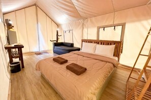 A tented room with a bed, a desk, and a chair. - Khaoyai Valley 9 (Pak Chong)