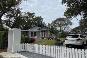 A residential house with a white picket fence, a driveway, and a parked car. - Khaoyai Valley 9 (Pak Chong)