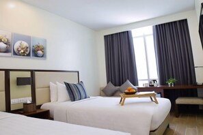 A hotel room with two beds, a desk, and a large window with curtains. - MCollection - Private Rooms in Historic Manila Chinatown (Manila)