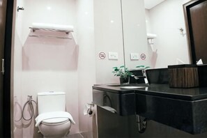 A modern bathroom with a toilet, bidet, and a sink with a mirror. - MCollection - Private Rooms in Historic Manila Chinatown (Manila)