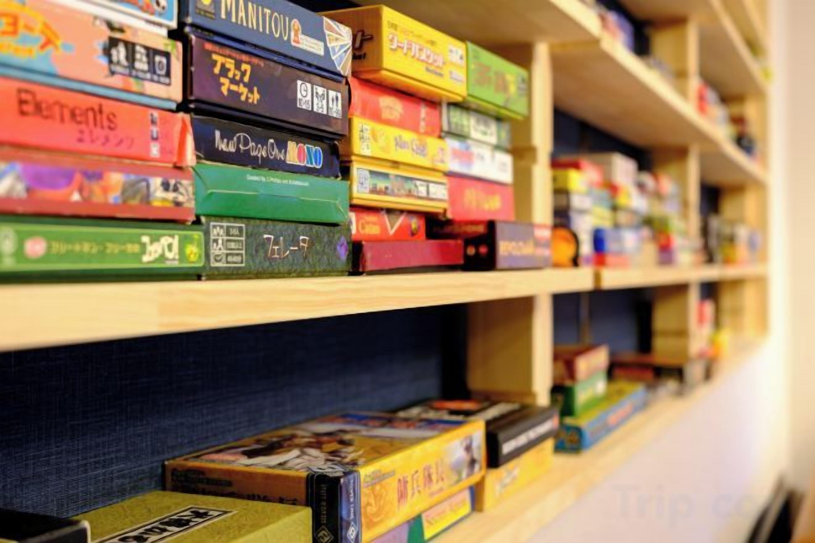 A shelf with various board games.