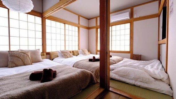 A traditional Japanese-style room with tatami flooring, sliding doors, and a low wooden ceiling. - Board Game House Tokyo (Tokyo)