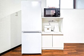 A compact kitchen with a white refrigerator, microwave, and coffee maker on a wooden countertop. - 【Family Welcome】Maisonette 3LDK in Yayoi-cho, Itabashi Ward (110㎡) (Tokyo)