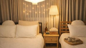 A hotel room with two beds, a nightstand, a lamp, a clock, and a tray with a mug and a book. - Turtle Stay Seoul-- the Center of Seoul #Cozy Apartment (Seoul)