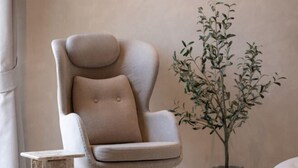 A modern armchair with a round backrest and a small table beside it. - Number Three Pool Villa Khaoyai (Pak Chong)