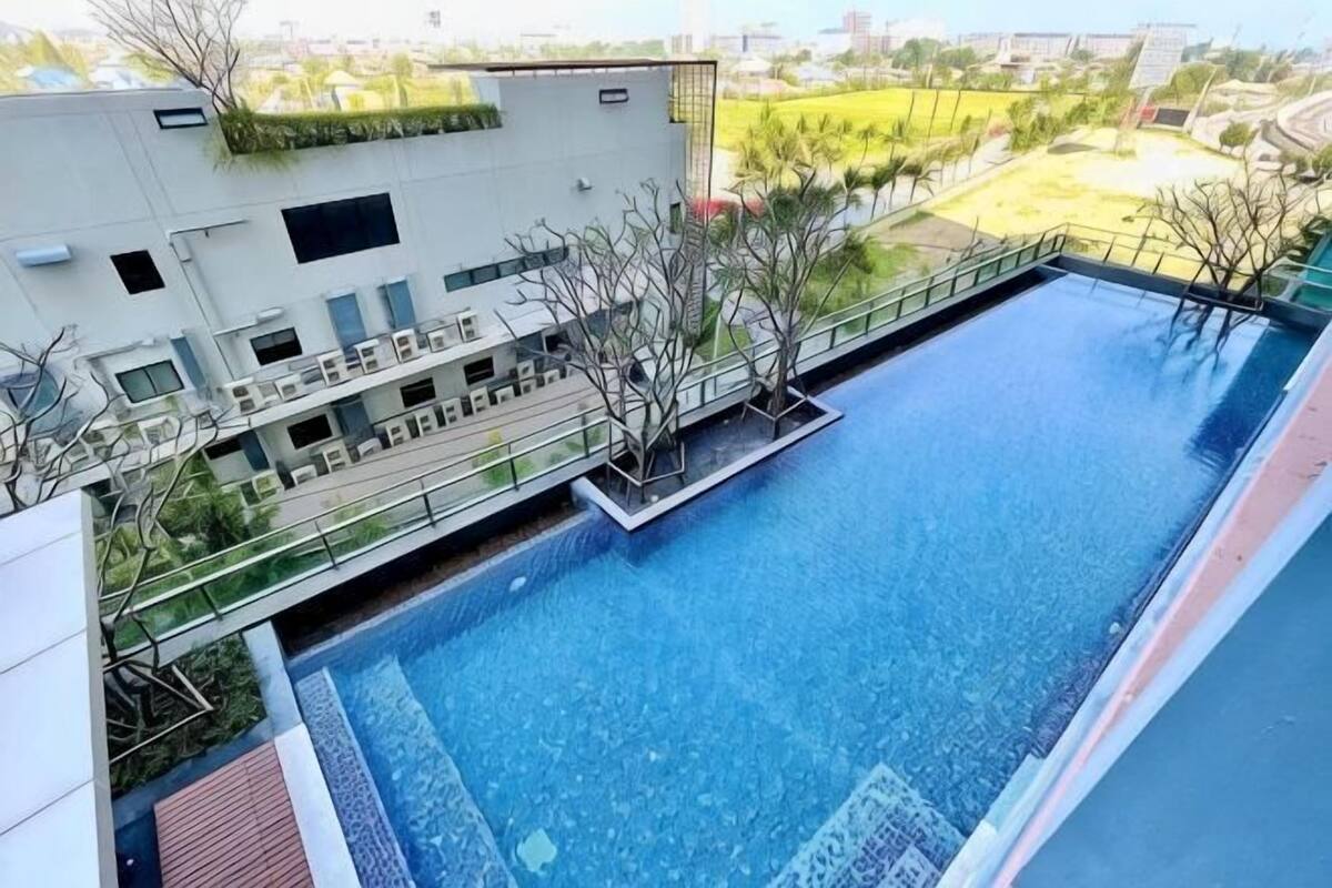 A rooftop pool with a modern building in the background.