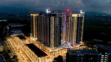 A high-rise hotel with multiple floors, a prominent entrance, and a well-lit facade.