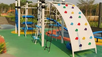 A playground with a climbing wall and slides.