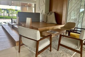 A modern living area with a sofa, chairs, and a coffee table. - KL Central 31st floor KLCC view (Kuala Lumpur)