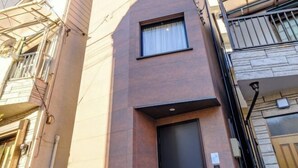 Une façade de bâtiment moderne avec une petite fenêtre et une porte.