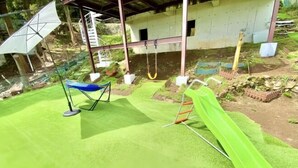 A playground with a slide, swings, and a climbing area. - Atami Tenku Villa Sky terrace (Atami)