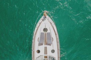 A boat with a cabin, two portholes, and a figurehead at the bow. - Point Residence (Auckland)