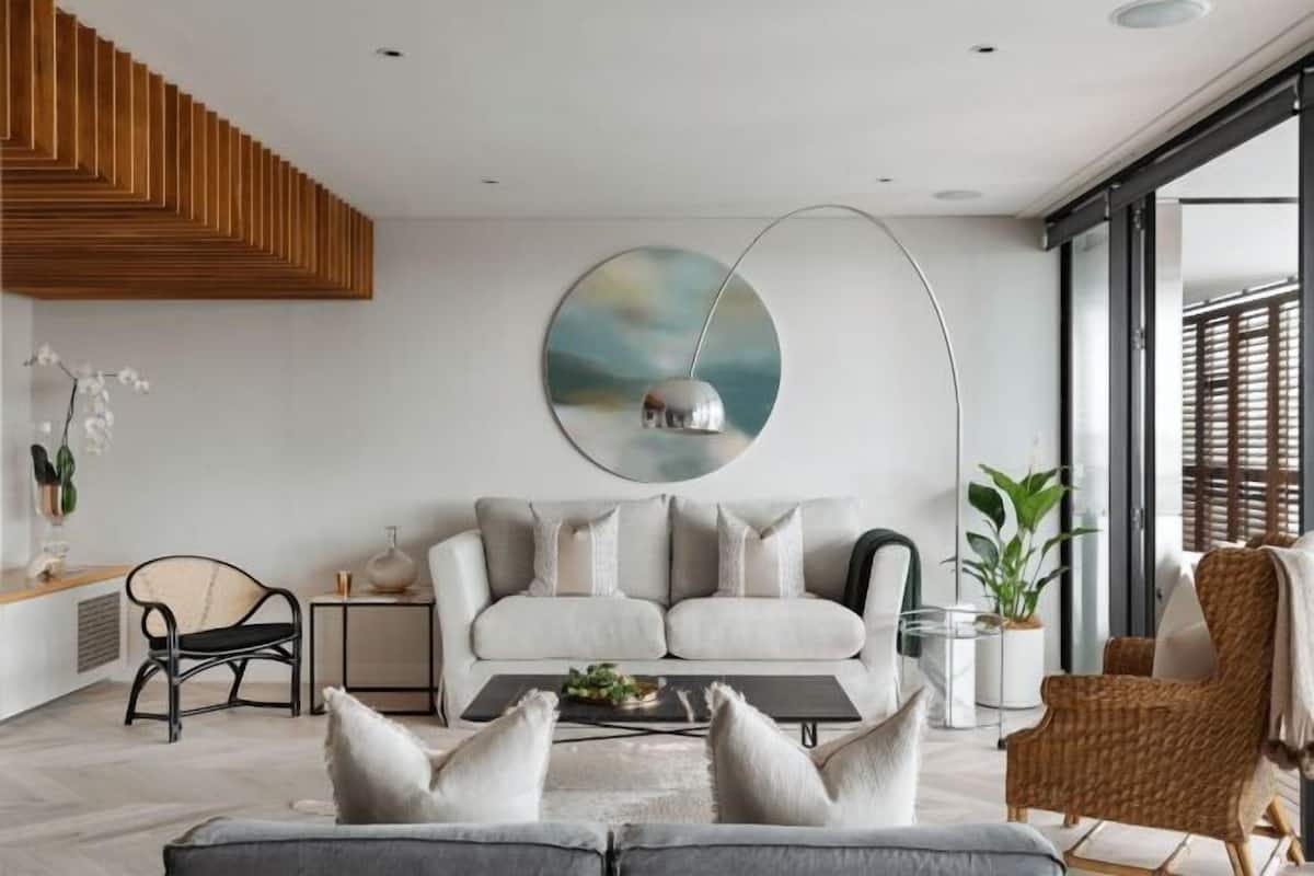 A modern living room with a sofa, coffee table, and decorative items.