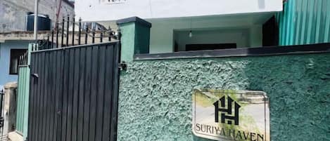 A gated area with a sign reading 'SURIYA HAVEN' on a textured wall.