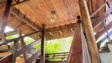 A wooden structure with a sloped roof and a lantern hanging from the ceiling.
