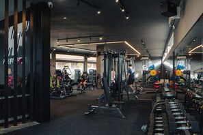 A gym with various exercise equipment, mirrors, and a well-lit interior. - Khaya Luxury Villas (Bali)