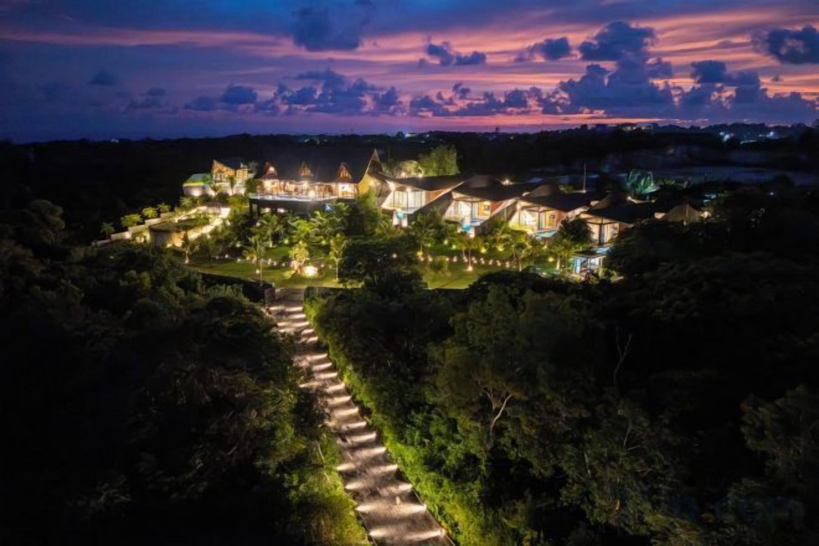 Un resort con varias edificaciones, un sendero bien cuidado y abundante vegetación.