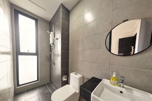 A bathroom with a toilet, sink, mirror, and shower. - Skyblue 2 Rooms Apartment, 4+2 Pax @ Urban Suites (George Town)