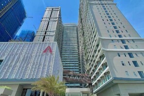 A high-rise building with a prominent 'A' logo on the facade, surrounded by other tall buildings. - The Song Vung Tau - Hong Hanh Apartments (Vung Tau)