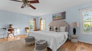 A bedroom with a bed, a desk, a chair, a ceiling fan, and a window. - Moment in Time - Hot Tub & Fire Pit (Fredericksburg)