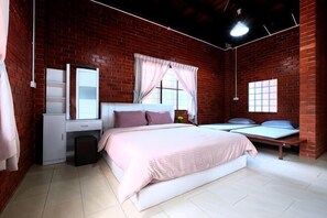 Ein Schlafzimmer mit Backsteinwand, einem Bett, einem Schminktisch und einem Fenster mit Vorhängen.