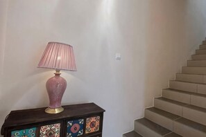 A staircase with a lamp on a cabinet. - JIA Residence 21 pax (Karaoke + Snooker) (Ipoh)