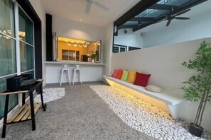 Un interior moderno con una zona de estar, una mesita y una planta en maceta.