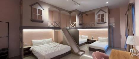 A bedroom with bunk beds, a desk, and a chair.