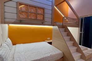 A bedroom with a bed, a window with a decorative screen, and a wooden staircase. - JIA Residence 21 pax (Karaoke + Snooker) (Ipoh)