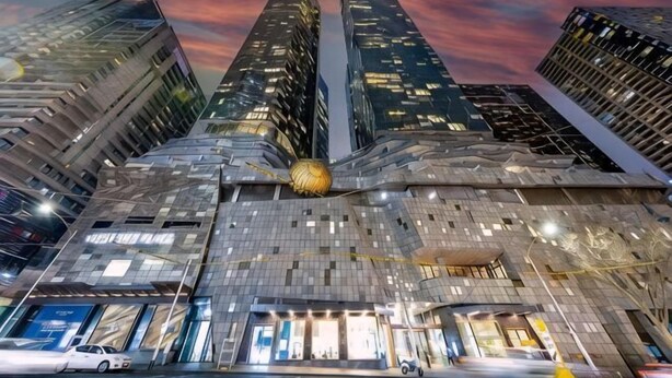 A modern building with a unique facade, multiple floors, and a prominent spherical structure in the center. - A Stylish 3BR Apt with Harbour Views, FREE Parking (Melbourne)