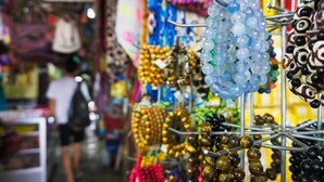 A market stall with various beads and ornaments displayed on racks. - Urban Retreat @ The Shore • CBD • Pool (Kota Kinabalu)