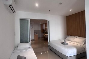 A modern hotel room with two beds, a kitchenette, and a bathroom. - Urban Retreat @ The Shore • CBD • Pool (Kota Kinabalu)