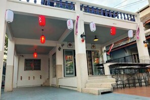 A building with a covered entrance, multiple windows, and outdoor seating. - Japanese style house, Bangsaen (Chon Buri)