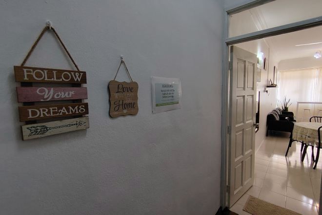 A hallway with wooden signs saying "FOLLOW Your DREAMS" and "Love Your Home."