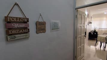 A hallway with wooden signs saying "FOLLOW Your DREAMS" and "Love Your Home."