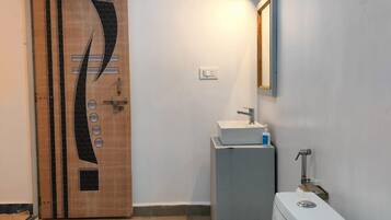 Casa de banho com design moderno, incluindo sanita, lavatório e espelho.