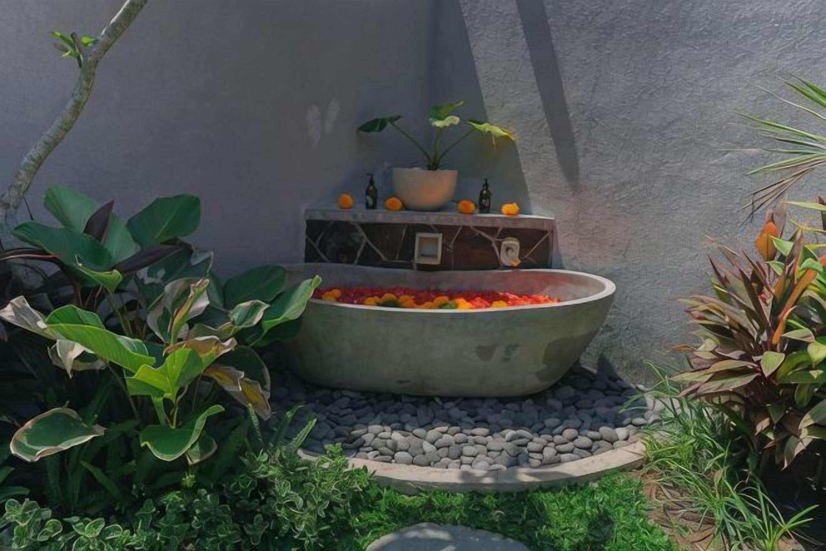 A concrete planter with a fire feature, surrounded by plants and a small step.