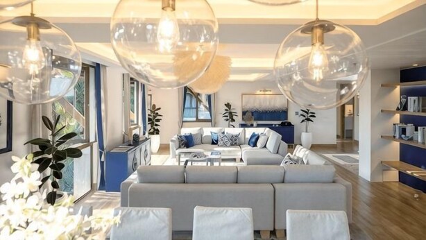A modern living room with a sofa, coffee table, and large glass pendant lights. - Phuket Royal Marina & Resort 4 bedroom Penthouse (Phuket)