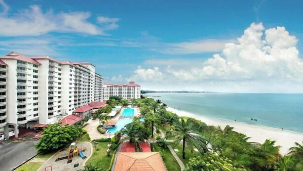 A hotel with multiple floors, a swimming pool, and a beach view. - 3 Bedroom Blissful Suite, Glory Beach Resort (Port Dickson)