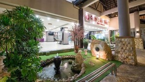 A commercial space with a water feature, stone structures, and indoor plants. - 3 Bedroom Blissful Suite, Glory Beach Resort (Port Dickson)