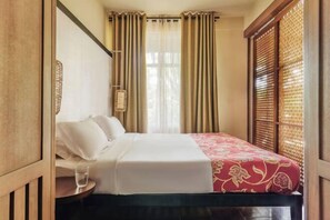 A hotel room with a bed, a bedside table with a glass of water, and curtains. - Club Med la Pointe Aux Canonniers (Grand Baie)