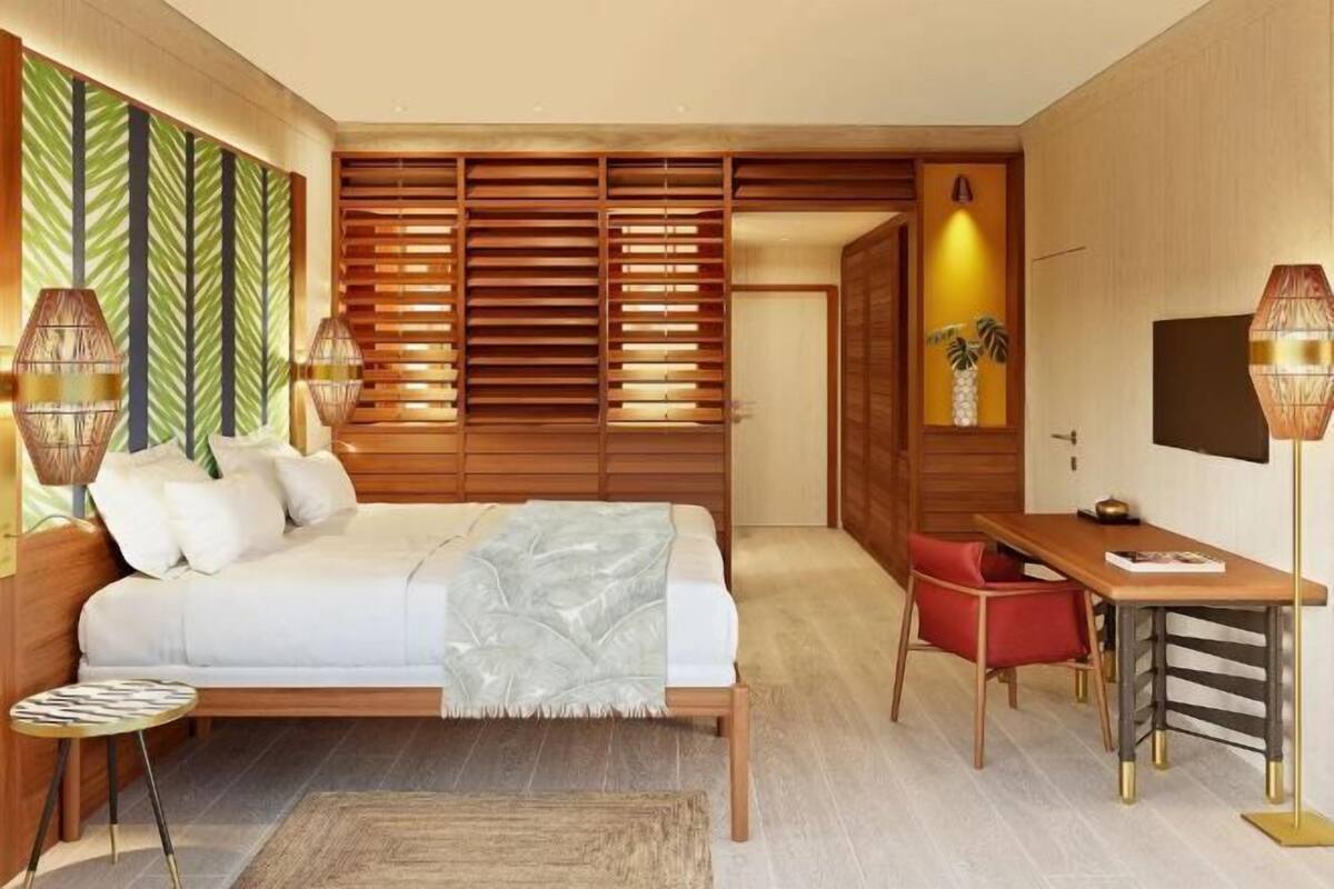 Un dormitorio moderno con cama, mesita de noche y escritorio con silla.