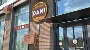 A hotel named 'DAMI' with a sign indicating it is a 'hotel'.