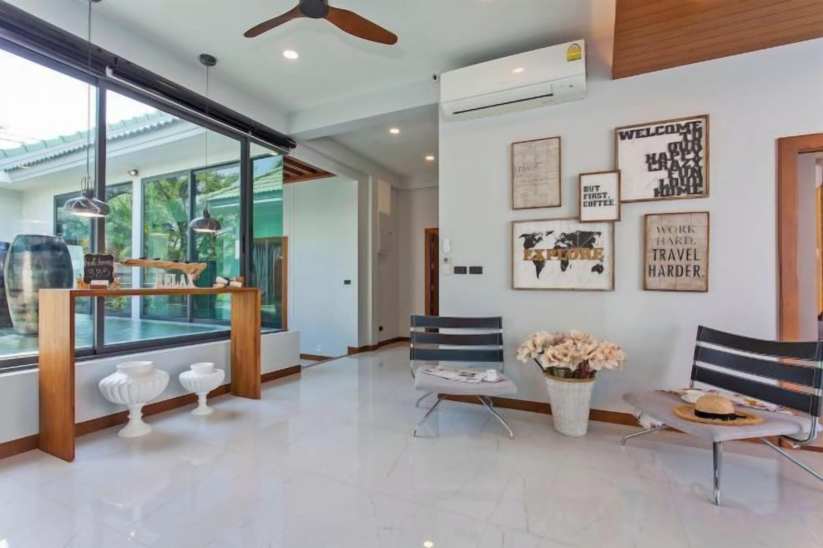 A modern interior with a seating area, a coffee table, and a large window.