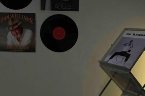 A wall with vinyl records and album covers. - OH Trendy homes Hoan Kiem LTK Bancony City view (Hanoi)