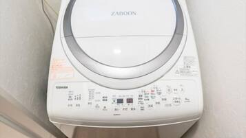 A white washing machine with a control panel, brand name 'ZABOON,' and 'TOSHIBA' label.