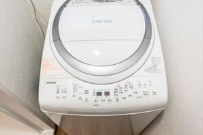 A white washing machine with a control panel, brand name 'ZABOON,' and 'TOSHIBA' label. - Tokyo Dome City Amusement Park Homestay (Tokyo)