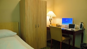 A hotel room with a bed, a desk with a computer, a lamp, and a chair. - Hotel Rosenhof am Main (Offenbach am Main)