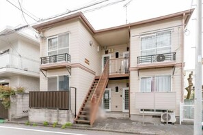 A two-story residential building with a staircase leading to the upper floor, a balcony, and a small front porch. - Sparrow Color · Fangnan (Tokyo)
